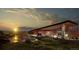 Striking community clubhouse with modern design, lush landscaping, and ample parking at 3929 Treadway Pt, Castle Rock, CO 80108