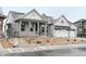 Charming home with covered porch, three-car garage, and low maintenance landscaping at 3929 Treadway Pt, Castle Rock, CO 80108