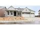 Charming home featuring a stone facade, covered porch, three-car garage and low maintenance landscaping at 3929 Treadway Pt, Castle Rock, CO 80108