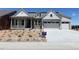 Charming single-Gathering home featuring a welcoming porch, stone accents, and a two-car garage at 3929 Treadway Pt, Castle Rock, CO 80108
