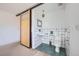 Bathroom featuring sliding barn door, black and white tiles, and contemporary fixtures at 801 Confidence Dr # 9, Longmont, CO 80504