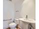 Half bathroom featuring a pedestal sink and toilet at 801 Confidence Dr # 9, Longmont, CO 80504