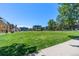 Lush green space surrounded by colorful modern buildings and mature trees, creating a serene community environment at 801 Confidence Dr # 9, Longmont, CO 80504