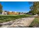 Exterior shot of vibrant modern apartment buildings surrounding a large green lawn on a clear day at 801 Confidence Dr # 9, Longmont, CO 80504