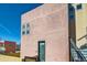 Modern pink-toned home exterior with windows and metal stairway at 801 Confidence Dr # 9, Longmont, CO 80504
