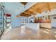 Bright, open kitchen with stainless steel appliances, a large island, and high ceilings with wooden beams at 801 Confidence Dr # 9, Longmont, CO 80504