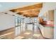 Open-concept living space featuring a modern kitchen, stainless steel appliances, and wood-beamed ceilings at 801 Confidence Dr # 9, Longmont, CO 80504