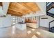 Spacious living area features modern kitchen, stainless appliances, wood beams, and adjacent modern staircase at 801 Confidence Dr # 9, Longmont, CO 80504
