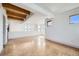 Bright living room with exposed wood beam ceiling and multiple windows at 801 Confidence Dr # 9, Longmont, CO 80504