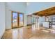 Bright, airy living room with tall ceilings, wooden beams, and large doors to bring the outside in at 801 Confidence Dr # 9, Longmont, CO 80504