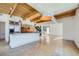 Spacious living area with a modern kitchen, stainless steel appliances, and stylish wood-beamed ceilings at 801 Confidence Dr # 9, Longmont, CO 80504
