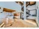 Open concept living space with modern staircase, wood-beamed ceilings, kitchen, and lots of natural light at 801 Confidence Dr # 9, Longmont, CO 80504