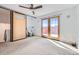 Bedroom featuring sliding barn door to the bathroom and sliding doors to the outside at 801 Confidence Dr # 9, Longmont, CO 80504