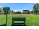 A peaceful park featuring a bench and sign, surrounded by modern architecture and vibrant landscaping at 801 Confidence Dr # 9, Longmont, CO 80504