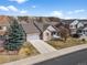 An aerial view of a well-maintained home featuring a stone facade, two-car garage, and a landscaped yard at 3966 Aspen Hollow Ct, Castle Rock, CO 80104