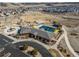 Aerial view of a neighborhood community with pool, clubhouse, and open space surrounded by homes at 3966 Aspen Hollow Ct, Castle Rock, CO 80104