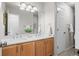 Bathroom featuring dual sinks, wood cabinets and ample counter space at 3966 Aspen Hollow Ct, Castle Rock, CO 80104