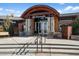 The Pinnacle's front entrance featuring stone pillars, glass doors, and an arched wooden awning at 3966 Aspen Hollow Ct, Castle Rock, CO 80104