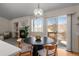 Sunlit dining area with fireplace and access to the outdoor deck at 3966 Aspen Hollow Ct, Castle Rock, CO 80104