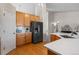Bright kitchen showcasing wooden cabinets, stainless steel appliances, and open layout to the home's stairway at 3966 Aspen Hollow Ct, Castle Rock, CO 80104