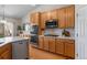 Bright kitchen features stainless steel appliances, a center island and wood cabinets at 3966 Aspen Hollow Ct, Castle Rock, CO 80104