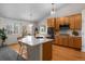 Bright kitchen featuring a large island with seating, modern light fixtures, and stainless appliances at 3966 Aspen Hollow Ct, Castle Rock, CO 80104
