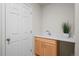 Convenient powder room features a small vanity and wood cabinets at 3966 Aspen Hollow Ct, Castle Rock, CO 80104