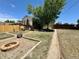 Spacious backyard with a wooden fence, garden beds, a fire pit, and access to a raised wooden deck at 1901 Clinton St, Aurora, CO 80010
