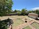 Large backyard featuring a shed, mature trees, a fire pit, and a wooden fence for privacy at 1901 Clinton St, Aurora, CO 80010
