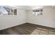 Spacious bedroom with wood-look flooring and two windows at 1901 Clinton St, Aurora, CO 80010