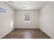 Simple bedroom with wood-look flooring and neutral walls at 1901 Clinton St, Aurora, CO 80010