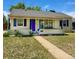 Charming single-story home features a cozy front porch swing, bright blue shutters and door, and a well-maintained lawn at 1901 Clinton St, Aurora, CO 80010