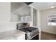 Stainless steel gas range and granite countertops in updated kitchen at 1901 Clinton St, Aurora, CO 80010