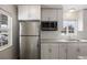 Bright kitchen with stainless steel refrigerator and white cabinets at 1901 Clinton St, Aurora, CO 80010