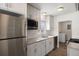 Modern kitchen with stainless steel appliances, white cabinets, granite countertops, and subway tile backsplash offers a clean and stylish space at 1901 Clinton St, Aurora, CO 80010
