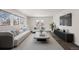 Stylish living room features a plush sofa, modern decor, and large windows offering a bright and comfortable space at 1901 Clinton St, Aurora, CO 80010