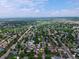 Expansive aerial view of the neighborhood and community, showcasing mature trees and winding streets at 10926 Dahlia Way, Thornton, CO 80233