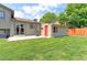 Large, green backyard with a patio area, storage shed, and wooden fence for privacy at 10926 Dahlia Way, Thornton, CO 80233