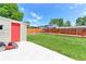 Well-manicured backyard featuring a storage shed, wooden fence, and lush green lawn at 10926 Dahlia Way, Thornton, CO 80233