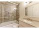 Modern bathroom with tiled shower with glass door, granite vanity, and built-in toiletries nook at 10926 Dahlia Way, Thornton, CO 80233