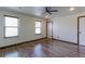 Bright bedroom with laminate floors, ceiling fan, and natural light from multiple windows at 10926 Dahlia Way, Thornton, CO 80233