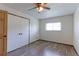 Bedroom with laminate flooring, ceiling fan, large closet, and natural light from a window at 10926 Dahlia Way, Thornton, CO 80233
