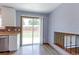 Bright kitchen with stainless steel dishwasher, updated backsplash and cabinets, and view of the backyard at 10926 Dahlia Way, Thornton, CO 80233