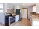 Modern kitchen with stainless steel appliances, updated backsplash and cabinets, and hardwood floors at 10926 Dahlia Way, Thornton, CO 80233