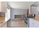 Modern kitchen with stainless steel appliances, updated backsplash and cabinets, and hardwood floors at 10926 Dahlia Way, Thornton, CO 80233