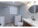 A bright laundry room with modern washer and dryer, stylish sink, and ample counter space at 10926 Dahlia Way, Thornton, CO 80233