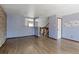 Inviting living room with hardwood floors, featuring a view of the staircase and pass through to the kitchen at 10926 Dahlia Way, Thornton, CO 80233