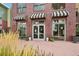 Charming exterior with striped awnings over large glass doors for plenty of light at the entrance to the facility at 3701 Arapahoe Ave # 106, Boulder, CO 80303