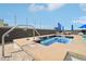 Rooftop hot tub and lounge area with blue umbrellas at 3701 Arapahoe Ave # 106, Boulder, CO 80303