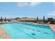 Rooftop pool with mountain views and blue umbrellas at 3701 Arapahoe Ave # 106, Boulder, CO 80303